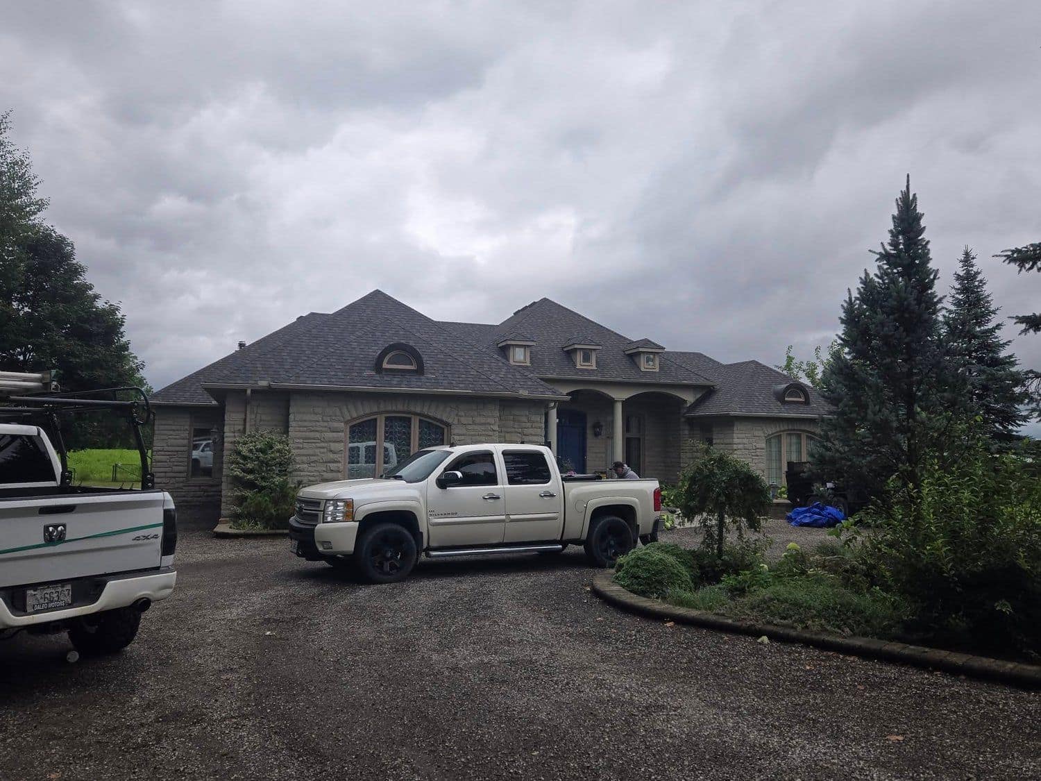 Mackie's Roofing truck on site at a residential reroof